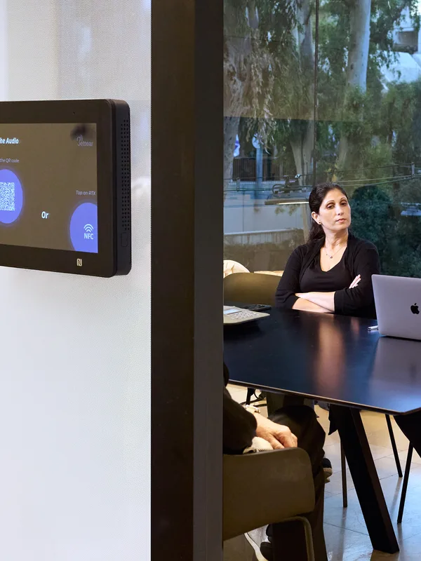 A meeting room with a B-PASS panel on the wall