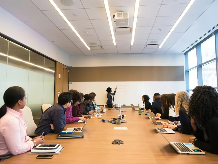 A team meeting around a long boardroom table