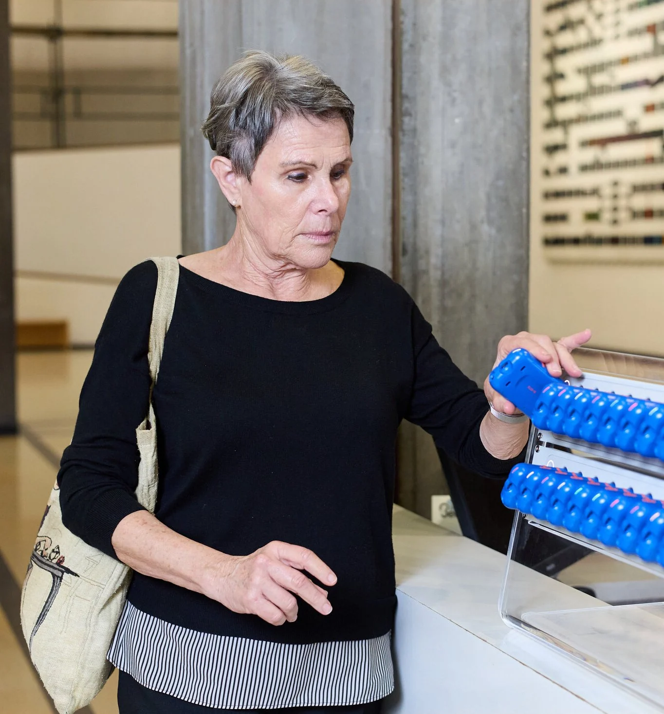 A visitor taking an RTX from a SmartHive at the museum entrance
