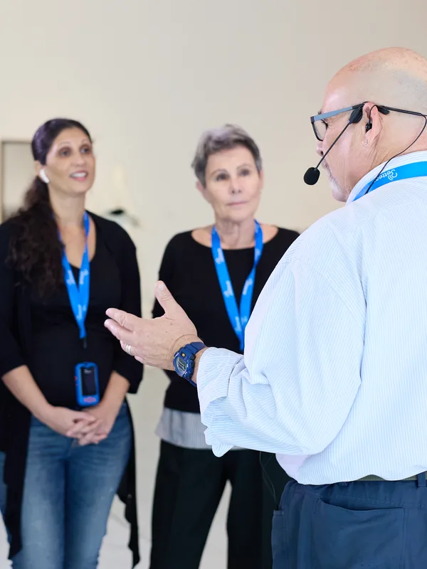 A museum guide talking to his group