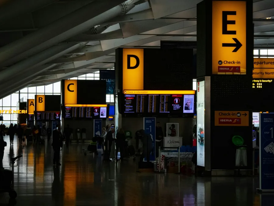 An airport terminal with gate signs