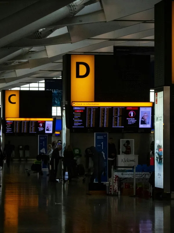 An airport terminal with gate signs